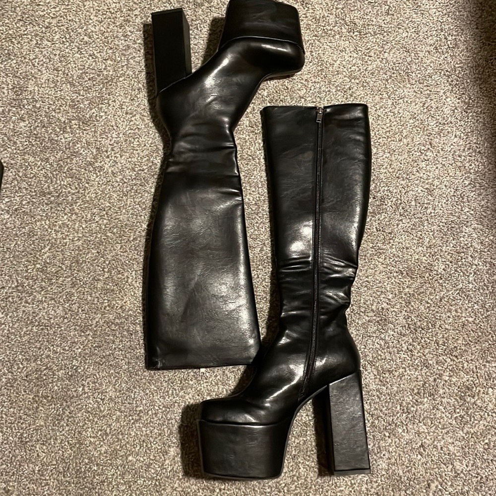 A new pair of black platform knee high boots from lamoda.